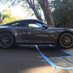 Low car using a DIY driveway ramp to prevent scraping