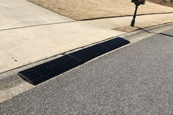 Rolled curb driveway ramp installed for smooth street-to-driveway transition