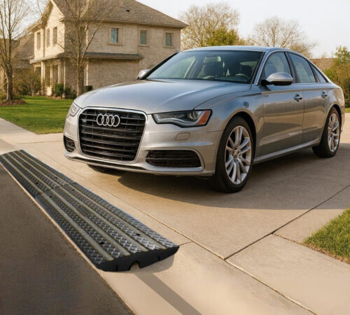 Driveway curb ramp for rolled curbs providing low car clearance and scrape protection