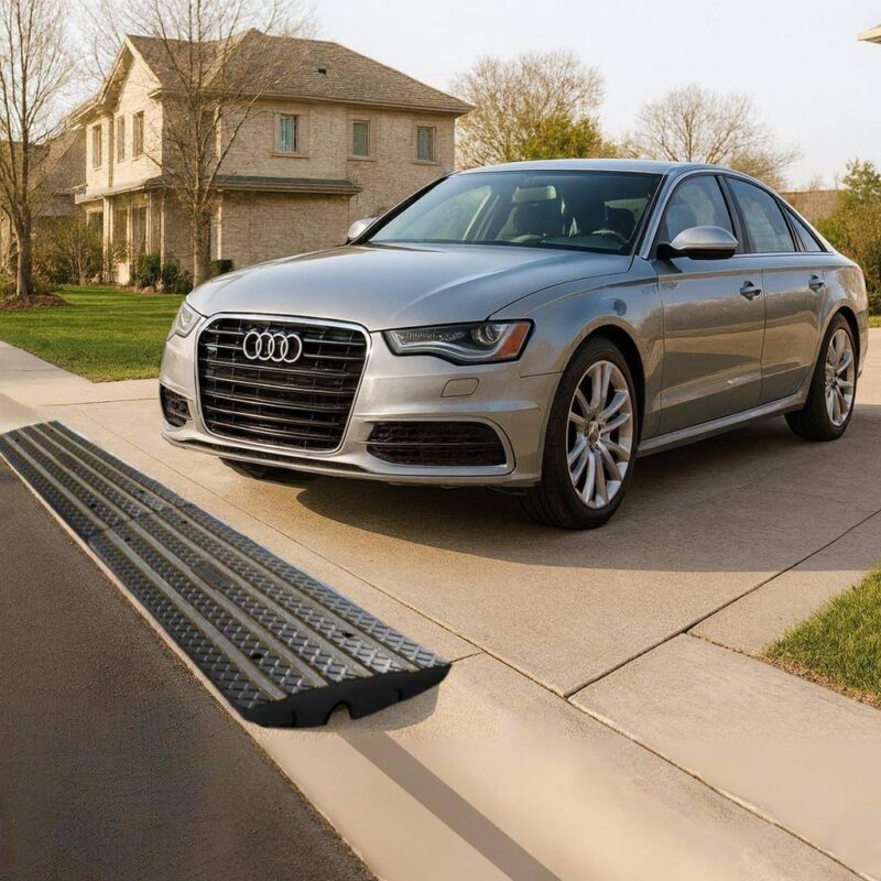 Driveway curb ramp for rolled curbs providing low car clearance and scrape protection