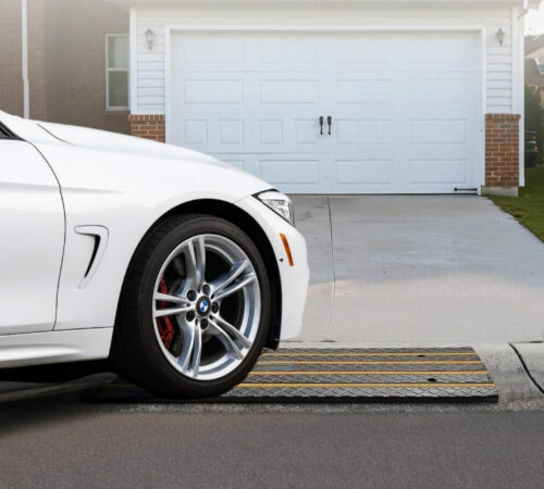Low car using driveway curb ramps for smooth entry over rolled curb
