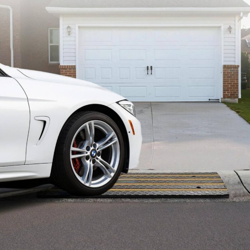 Low car using driveway curb ramps for smooth entry over rolled curb