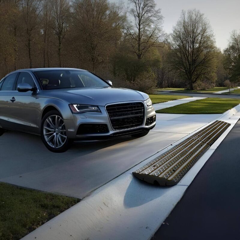 Rounded curb driveway ramp for low car clearance and steep driveway entry