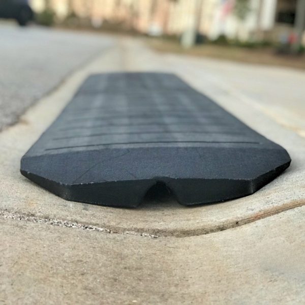 Rubber curb ramp side profile showing tapered design for smooth vehicle entry.