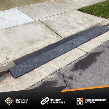 Rubber curb ramp installed for a steep driveway approach with a curb lip.