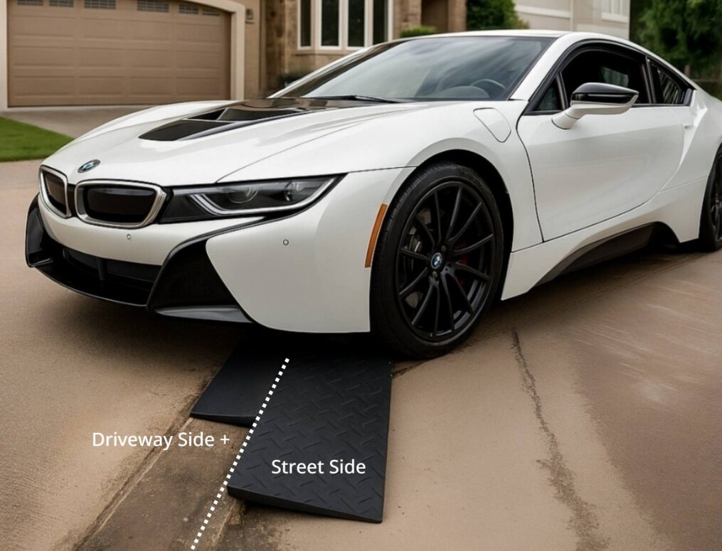 Two-Ramp Driveway Lip Clearance System for Low Sports Cars BMW i8 using a driveway-side and street-side ramp setup to cross a steep gutter lip without scraping the front bumper.