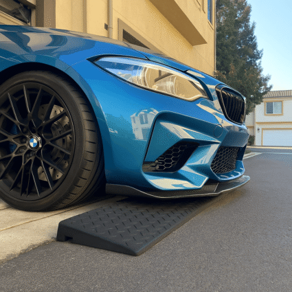 Blue BMW using rubber threshold ramp to prevent scraping at garage entry