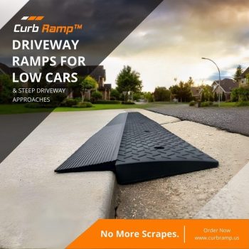 Black driveway ramp positioned on a curb at the end of a residential street, helping a low car navigate a steep driveway approach without scraping.