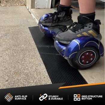 A low-profile rubber ramp at a garage threshold, allowing smooth hoverboard entry.