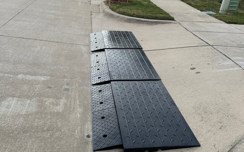 Modular ramp system installed on a steep driveway curb to improve vehicle clearance.