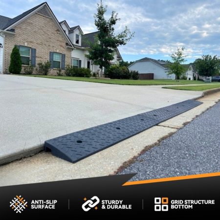 Rubber driveway ramp for smooth vehicle access over a steep curb and driveway apron.