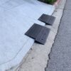 1.5-Inch Rolled Curb Driveway Ramps – Threshold Lip Clearance Setup Two 1.5-inch rubber ramps positioned on a rolled curb to smooth the driveway lip and help low cars cross without scraping.