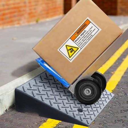 Heavy duty rubber curb ramp used for easy movement of a hand truck over a curb