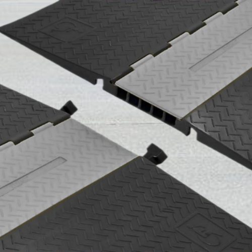 Modular interlock ramp system in gray and black for enhanced car clearance.