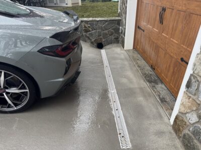 corvette-on-sloped-driveway-with-garage-lip-and-trench-drain-clearance-fix