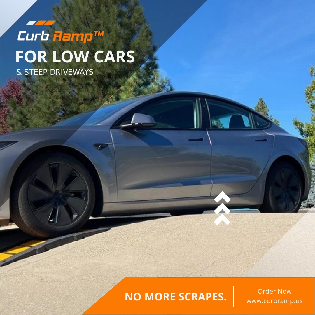 Low-clearance car climbing a steep driveway using a rubber driveway ramp to prevent front-end scraping.