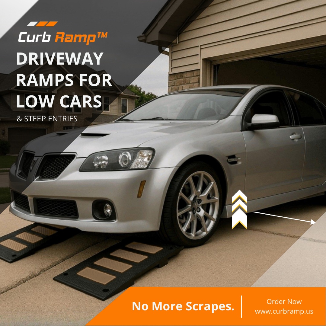 Silver car using modular driveway ramps to enter steep garage without scraping low front bumper