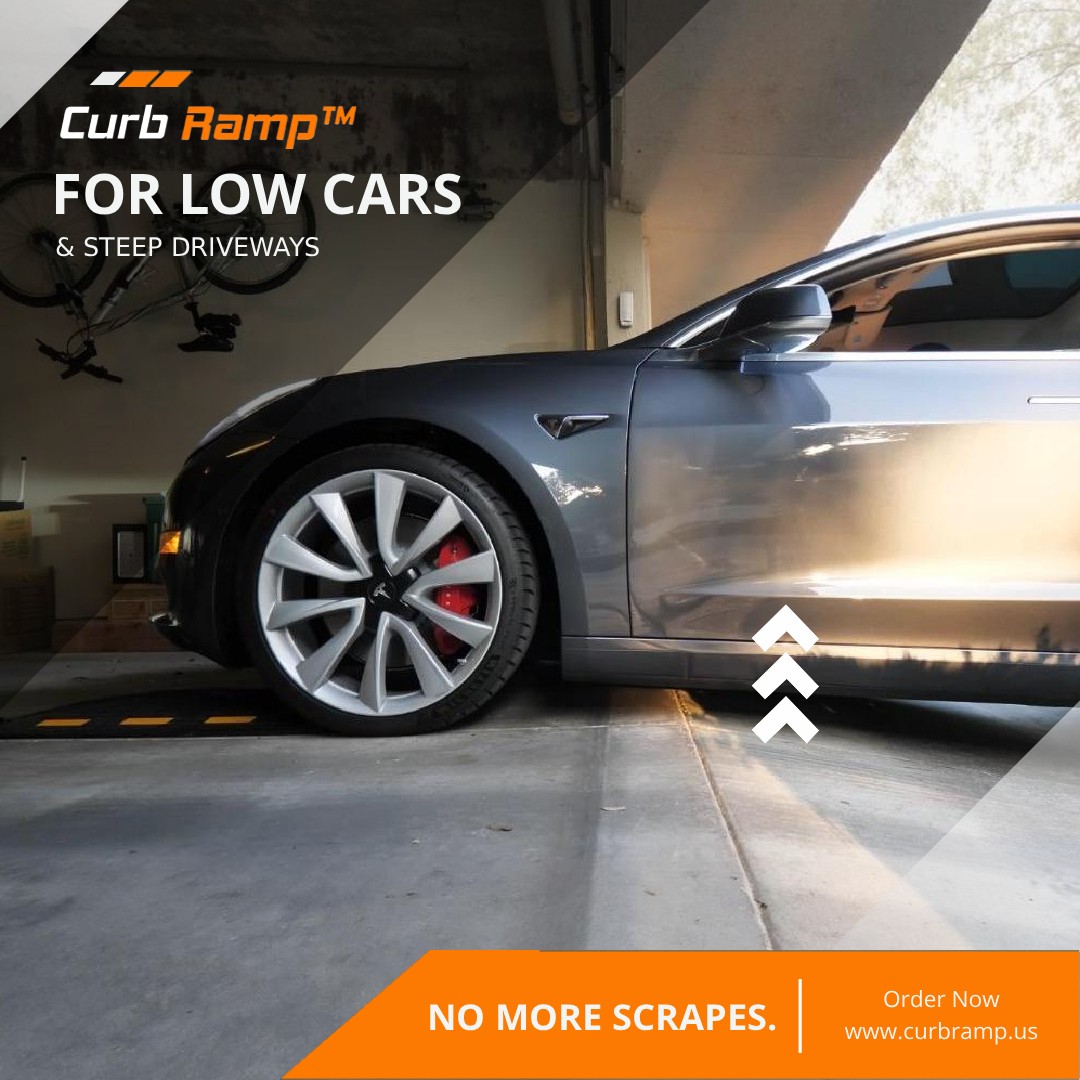 Low-clearance car entering a garage with a driveway ramp lifting the front tires to prevent scraping at the garage lip.