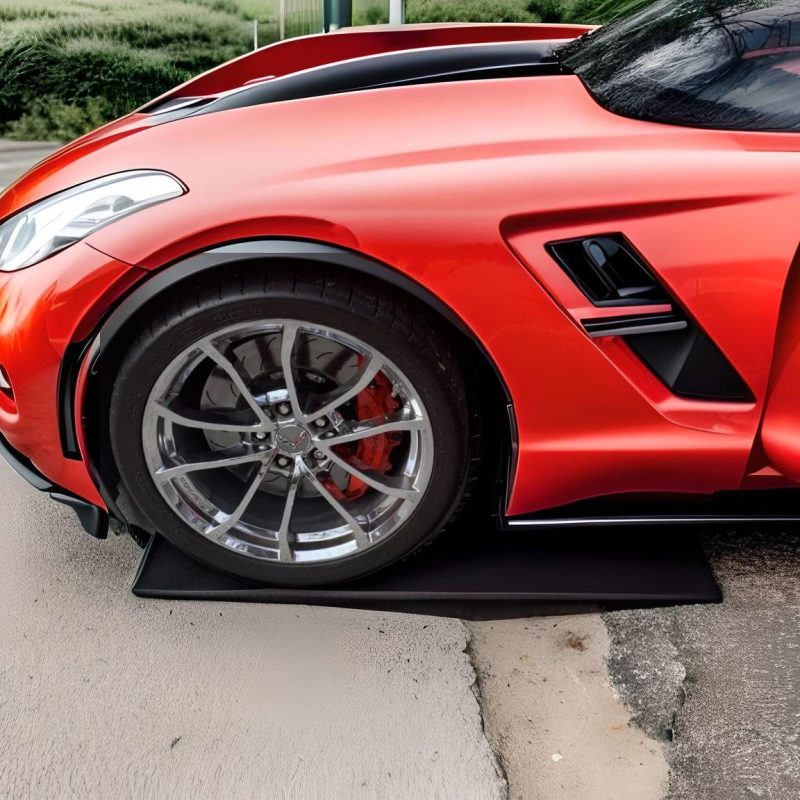 Low profile driveway ramps preventing splitter scraping for a red sports car on steep approaches