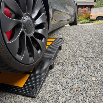 tesla-driving-over-curb-ramp-for-low-clearance-on-angled-driveway