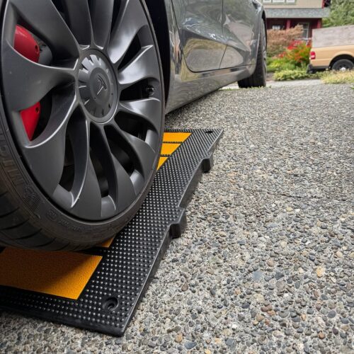 tesla-driving-over-curb-ramp-for-low-clearance-on-angled-driveway