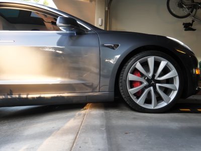 Vehicle with clearance issue on a steep decline, showing the need for a curb ramp solution.