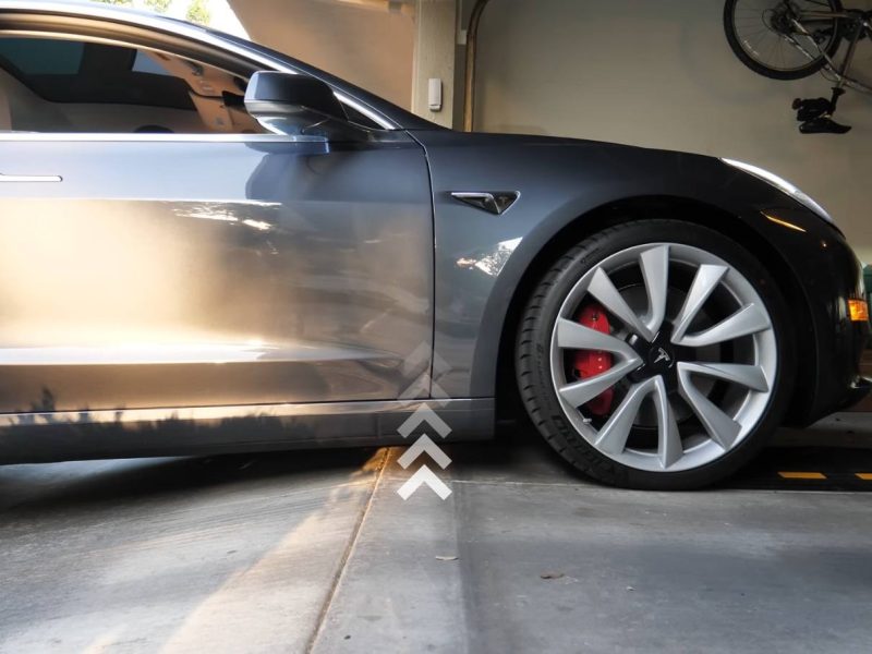 Vehicle with clearance issue on a steep decline, showing the need for a curb ramp solution.