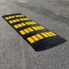 Wide modular rubber driveway ramp for rounded curb entry preventing scraping for low clearance vehicles