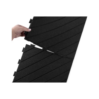 Hand assembling interlocking rubber ramp surface mats for durable driveway protection.