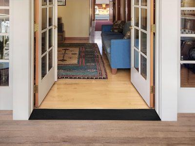 Rubber threshold ramp placed at the entrance of a home with open French doors, providing smooth entry for wheelchairs, strollers, and carts.