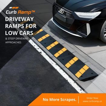 Rubber curb ramp installed along a driveway to protect a low-clearance car from scraping.