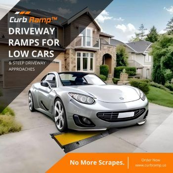 White car utilizing a curb ramp to safely drive over a steep driveway curb.