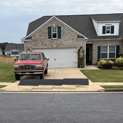 Driveway gutter mat installed for smooth truck access over curb