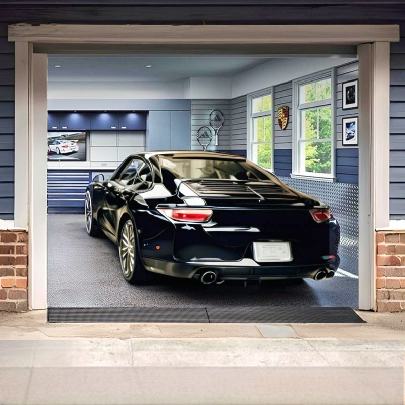 Black luxury sports car using a Curb Ramp™ to smoothly enter a residential garage, enhancing vehicle protection and driveway accessibility.