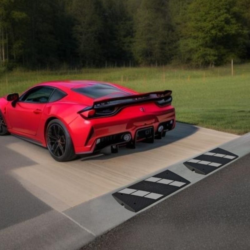 Red sports car on driveway equipped with our driveway ramp, showcasing effective protection against scrapes for low-clearance vehicles.