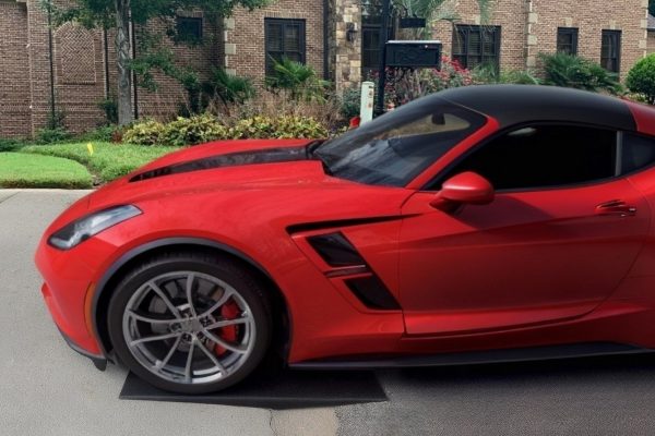 Red sports car using a Curb Ramp to easily access a steep driveway, preventing undercarriage scrapes and enhancing curb appeal.