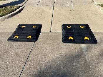 Two driveway ramps installed side by side, ensuring smooth clearance over steep driveway ridges.