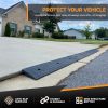 Anti-slip customizable driveway ramp installed on a steep driveway with a lip, providing a smooth transition for vehicles.