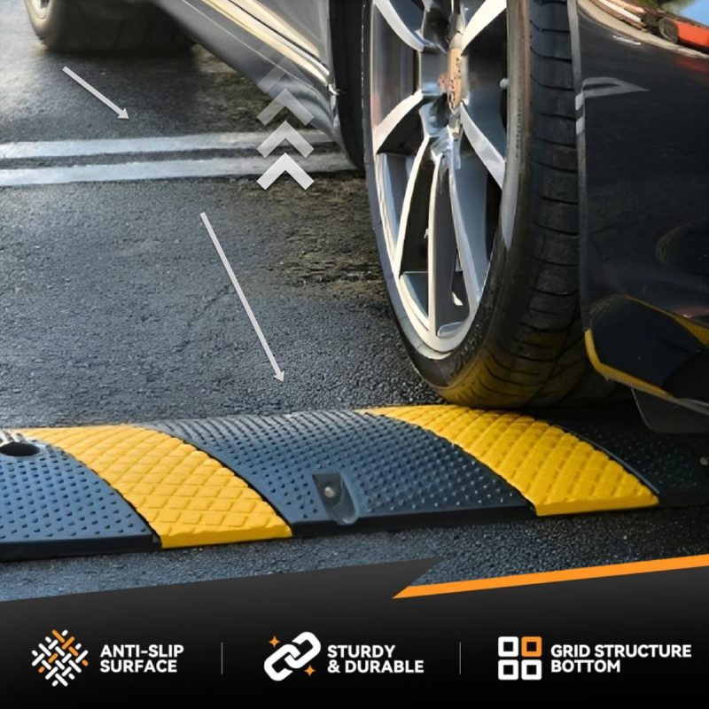 Close-up of a luxury car using a driveway ramp to prevent scraping over a steep driveway ridge.