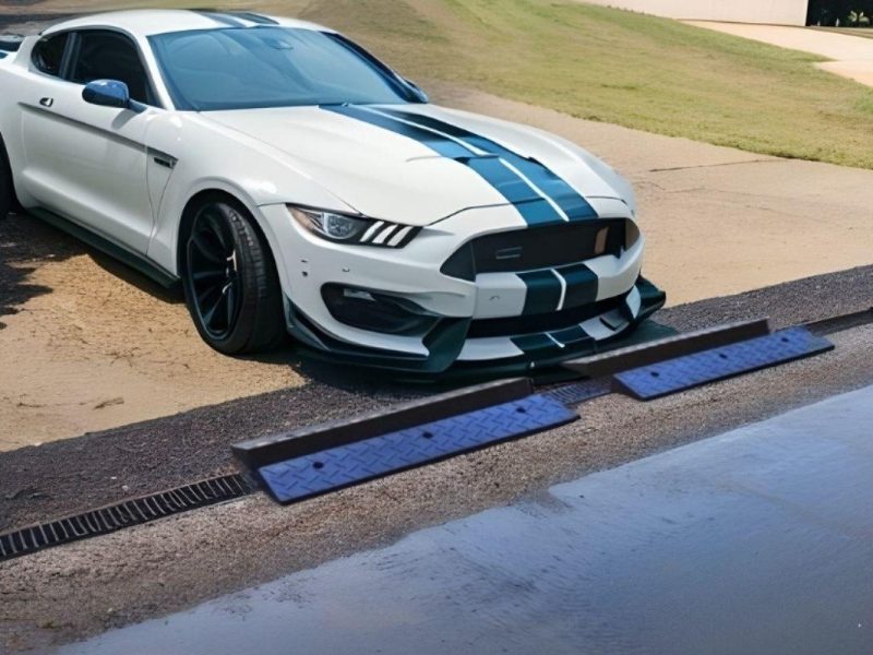 Low-clearance sports car using a garage entry ramp to prevent scraping on threshold lips.