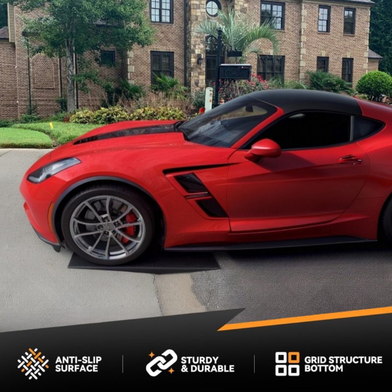 Red sports car using a low-profile driveway ramp to prevent scraping at the entry.