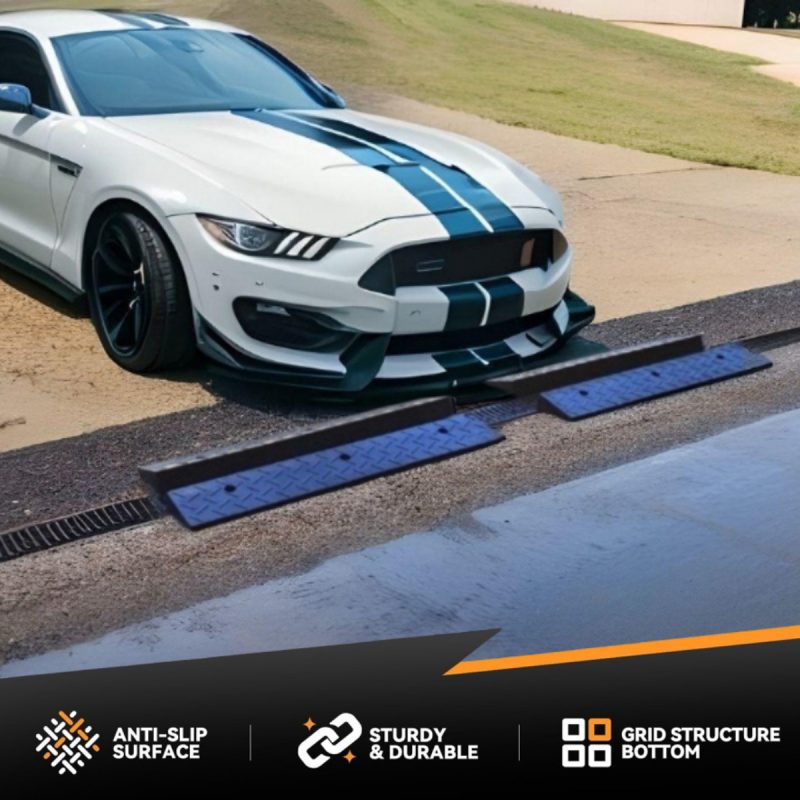 White sports car with blue racing stripes using garage entry ramps to prevent scraping on a steep driveway.