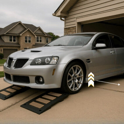 Low car using garage threshold ramps to prevent scraping on driveway drop-off