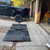 Steep Driveway-to-Garage Lip Transition Ramps for Smooth Vehicle Entry Heavy-duty rubber transition ramps placed over a steep driveway-to-garage lip to help a truck cross the threshold smoothly.