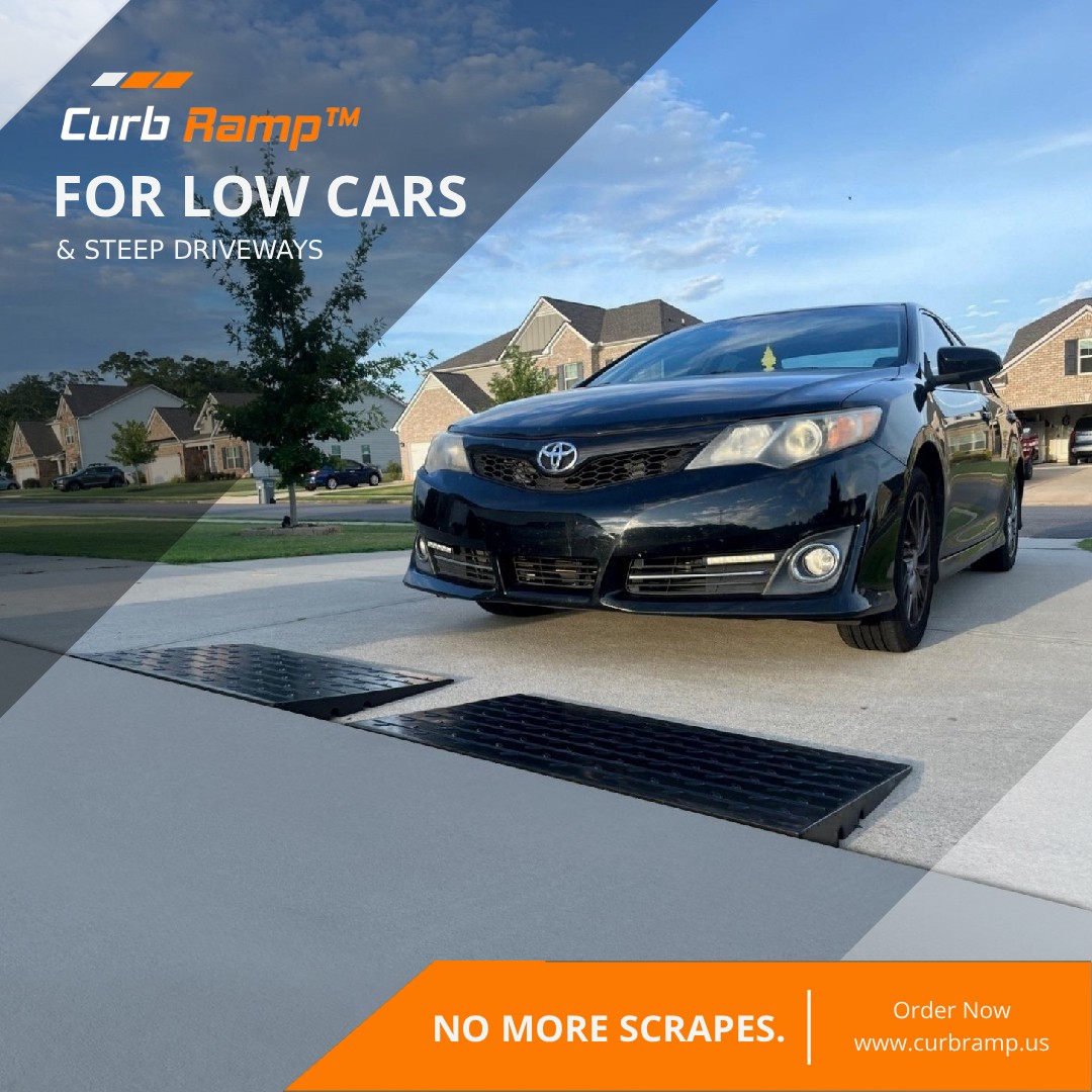 Low-clearance car approaching a steep driveway using rubber driveway ramps to prevent front bumper scraping.