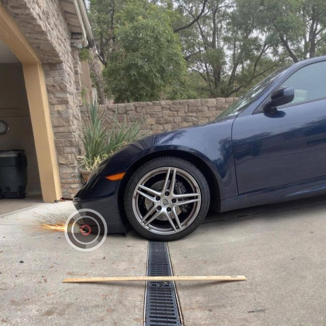 low-sports-car-scraping-garage-entry-steep-driveway-french-drain-clearance-problem